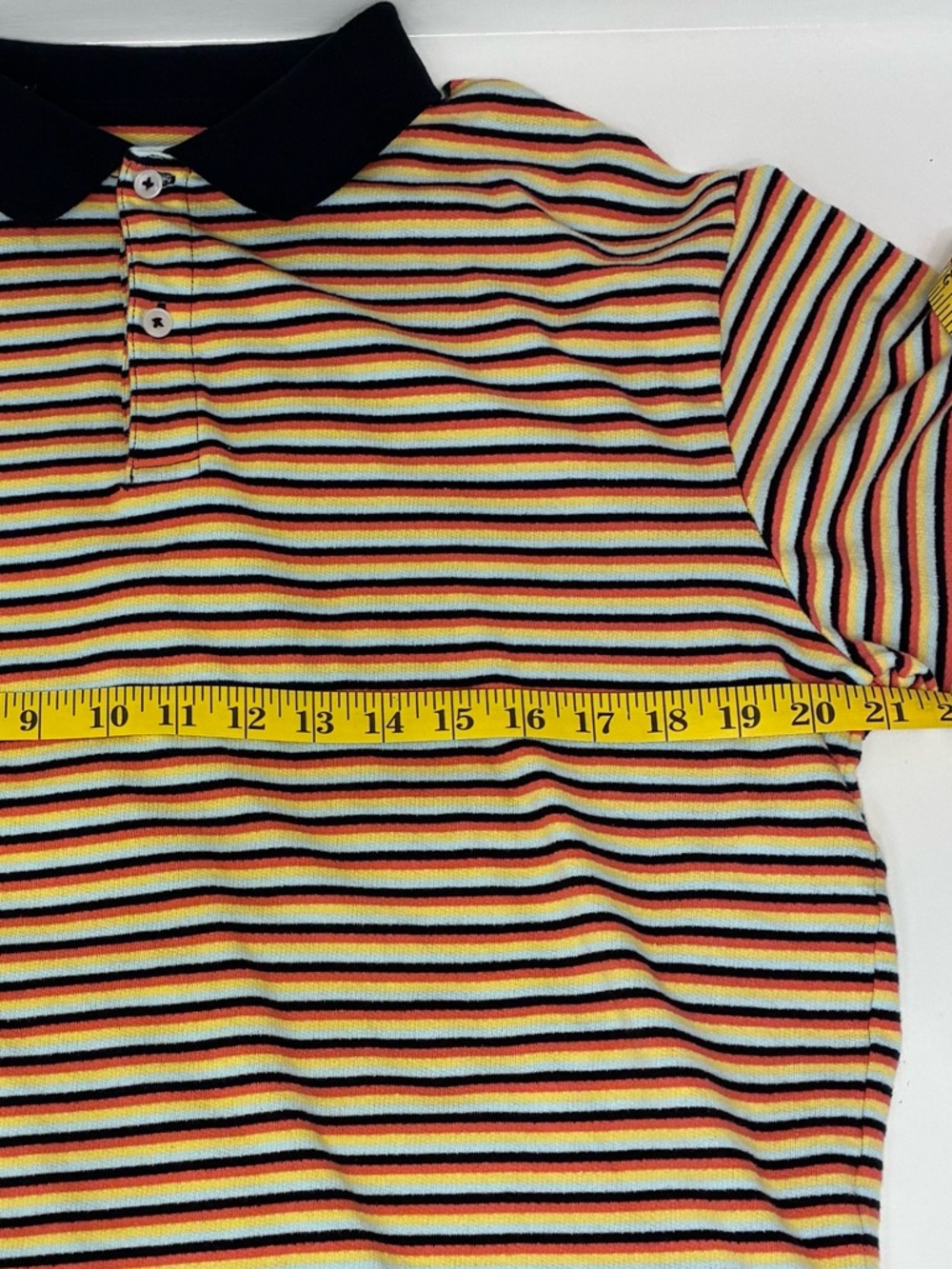 Original Use Men’s L Knit Jersey Polo w/ Orange, Blue, Black and Yellow Stripes.
